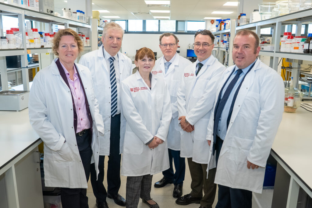 Economy Minister Caoimhe Archibald with university representatives at the iPHARMA investment announcement