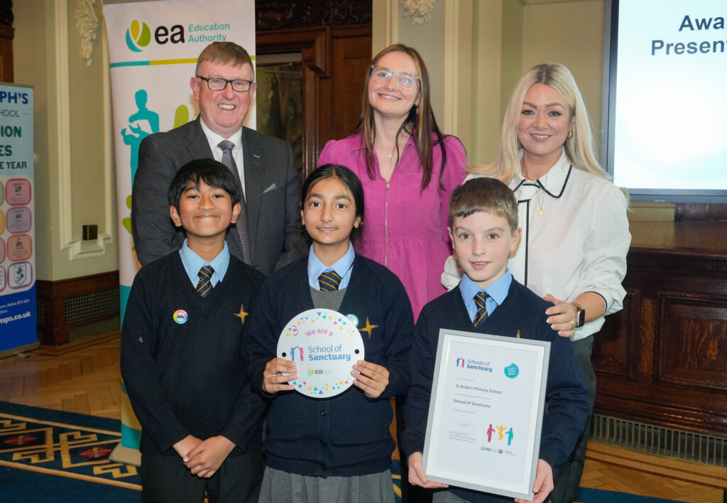 Mervyn Storey presenting St Bride's Primary School with its award
