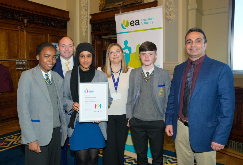 Mehrshad Esfandiara presenting Blessed Trinity College with its award