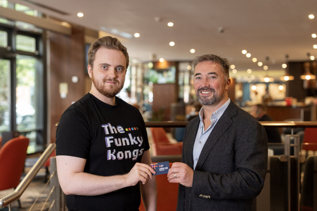 Linen Quarter BID Managing Director Chris McCracken with 5,000th reward card holder Sam Purnell