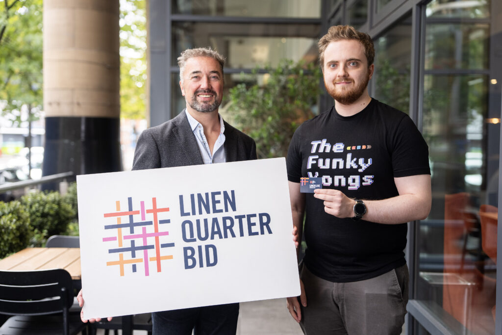 Linen Quarter BID Managing Director Chris McCracken with 5,000th reward card holder Sam Purnell