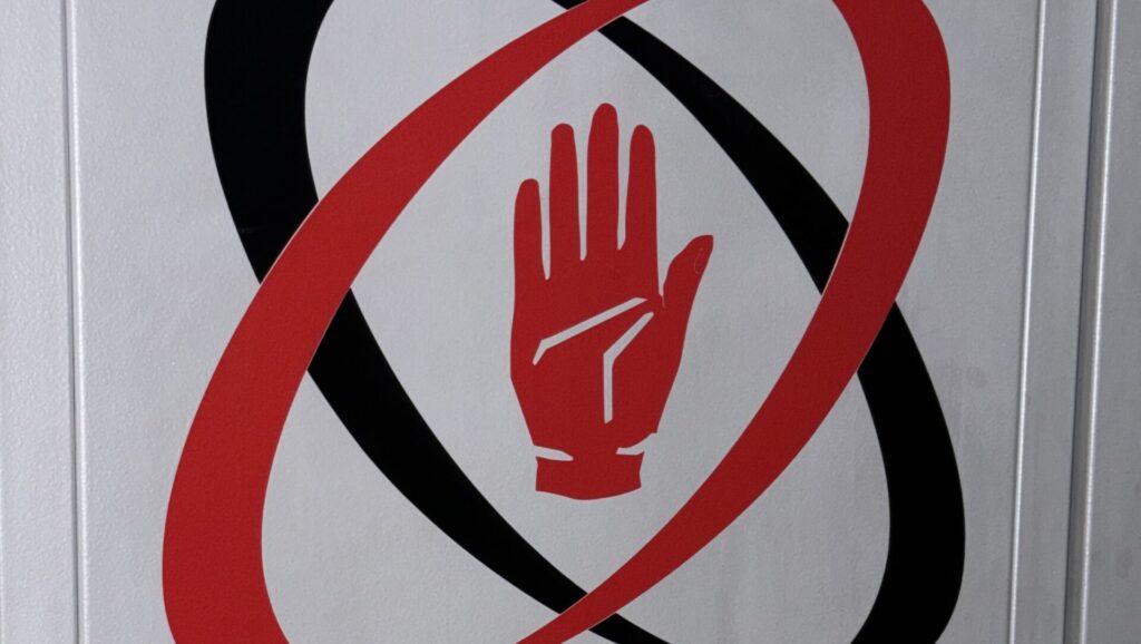 Ulster Rugby logo featuring the red hand of Ulster, photographed at the rugby club's Belfast stadium