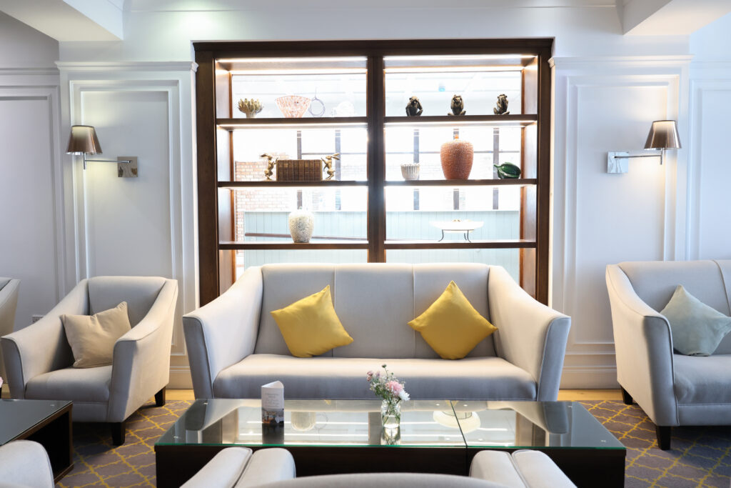 Refurbished lounge seating area at the Ivanhoe Hotel near Carryduff, featuring modern furnishings and decorative shelving