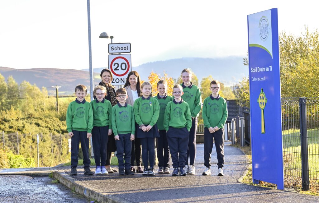 Infrastructure Minister Liz Kimmins with Ailish McNaughton and Dromintee Primary School pupils during the announcement of 34 new part-time 20mph school speed limits
