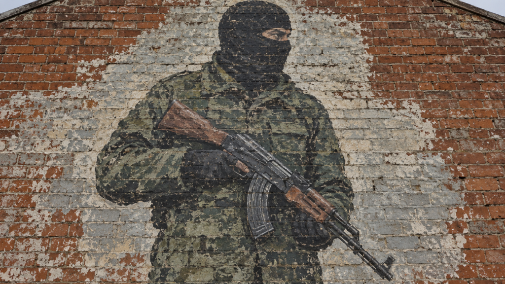 AI-generated mural illustration of a masked figure holding a rifle on a brick gable wall